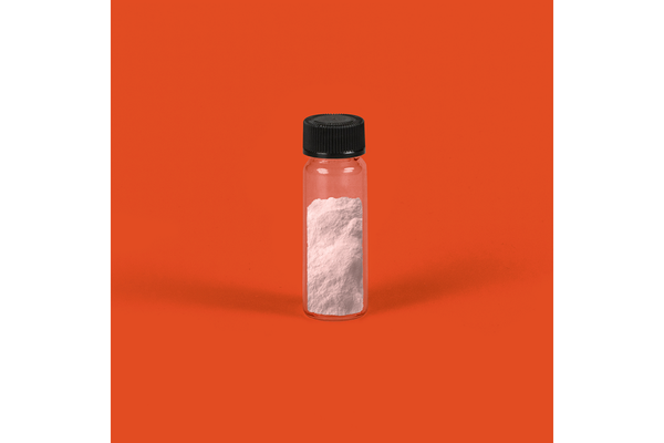A bottle of pink powder with an orange background.